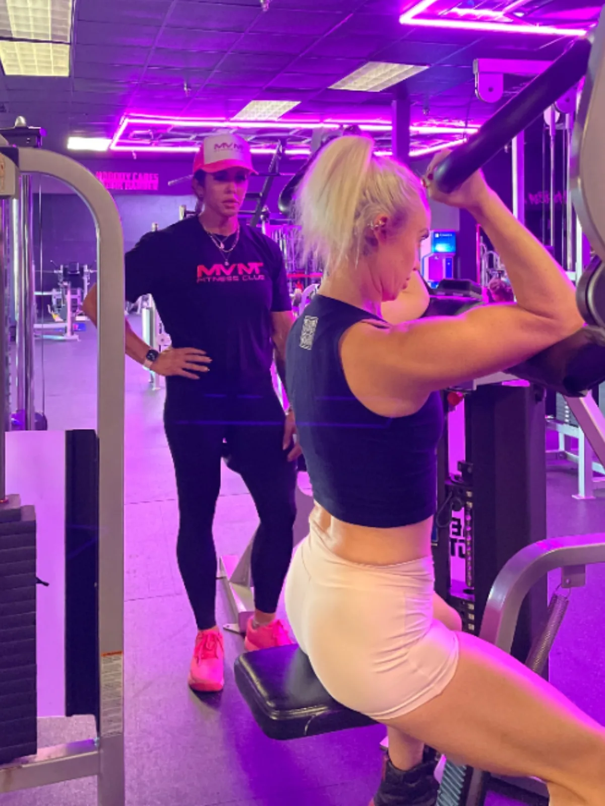 Annie coaching a client one-on-one during a small group session at MVMT Fitness Club