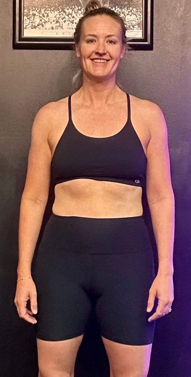 Jenni after 9 months of small group personal training at MVMT Fitness Club Scottsdale — confident, strong, and smiling in black athletic wear